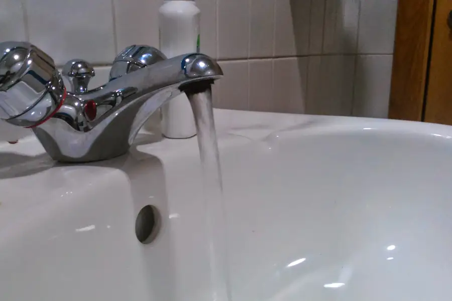 A running tap above a bathroom basin